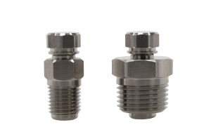PT PLUG - SS - Two stainless steel fittings with hexagonal tops and threaded bodies, shown against a white background. The fitting on the left is smaller and narrower than the one on the right.